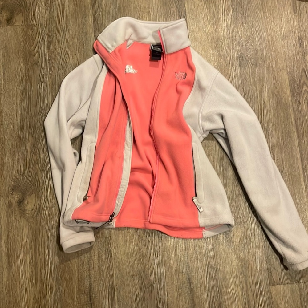 The north face women’s pink and grey fleece jacket